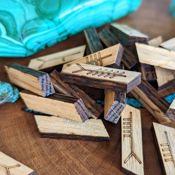 Arrow shaped wooden pieces on a wooden table.