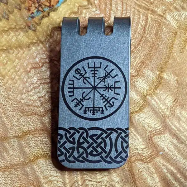 A money clip with a viking symbol on it.