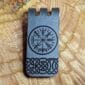 A money clip with a viking symbol on it.