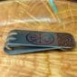 Viking money clip on a wooden plate.