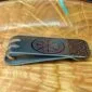 Viking money clip on a wooden plate.