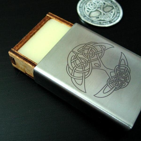 A wooden box with a celtic symbol on it.