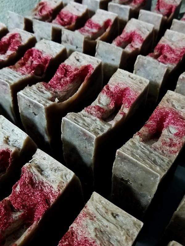 A bunch of bars of soap with red dye on them.