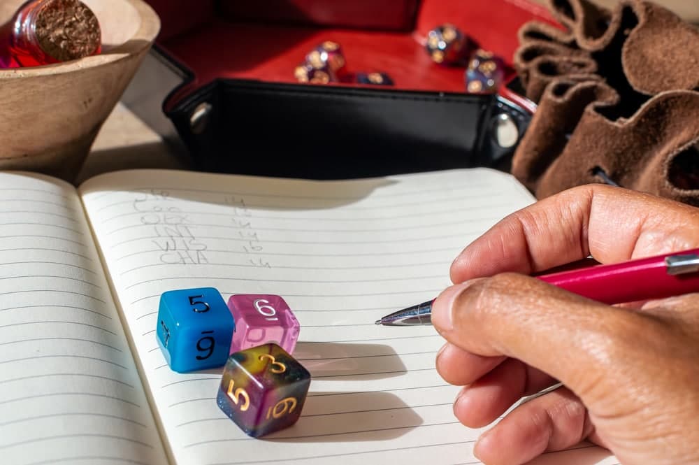 Close up of someone writing down character stats