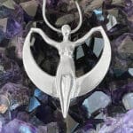 A Crescent Moon Goddess Pendant with a woman on it.
