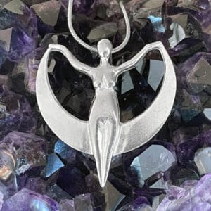 A Crescent Moon Goddess Pendant with a woman on it.