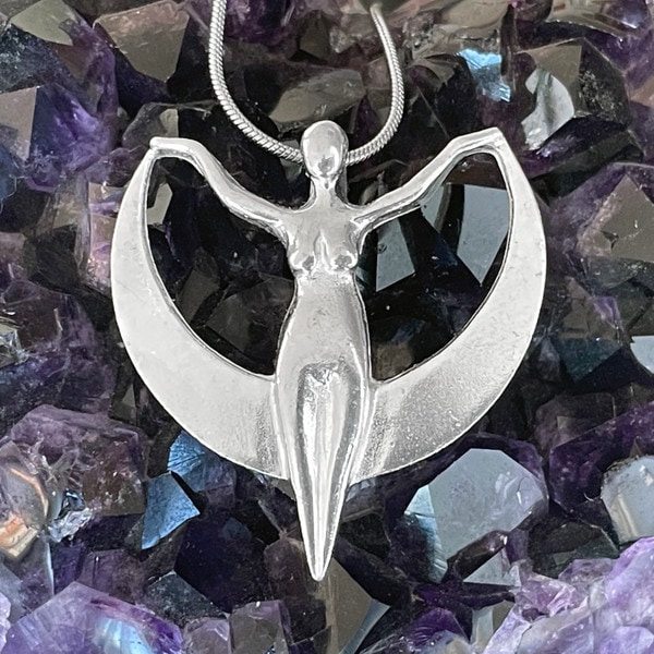A Crescent Moon Goddess Pendant with a woman on it.