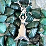 An Earth Elemental Necklace with a woman on it.