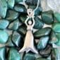 An Earth Elemental Necklace with a woman on it.