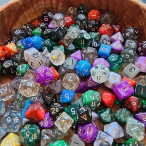 Mini Dice Refill Pack in a wooden bowl on a table.