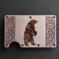 A Celtic Bear Titanium Minimalist Wallet featuring a bear design.