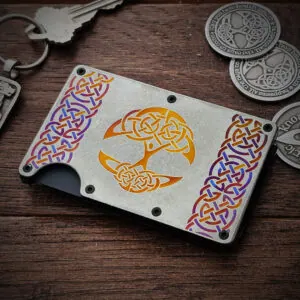 A Tree of Life Titanium Minimalist Wallet on a wood surface.