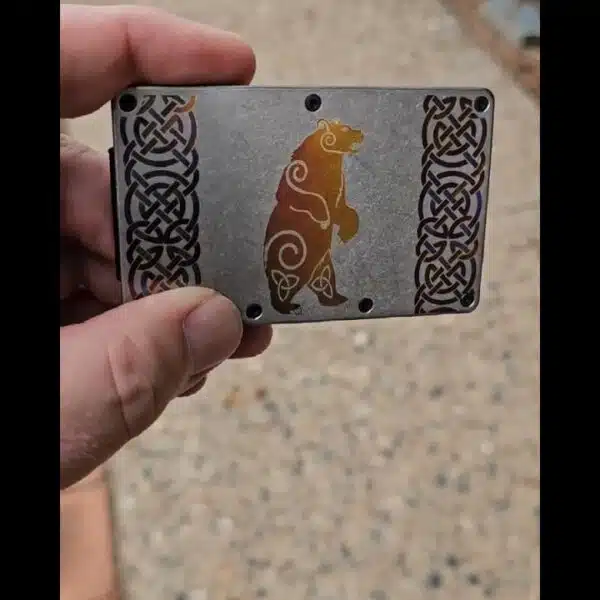 A person holding a metal plate with an image of a polar bear.