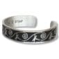 Dragonfly Dreams Bracelet: A silver cuff with a black background, embellished with dragonfly and swirl designs. The inside is engraved with the text "make it true".