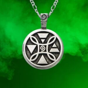 The 4 Elements Pendant, featuring geometric symbols in silver, hangs on a chain against a green smoky background.