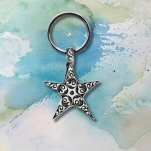 Star Keychain featuring intricate swirl patterns on a watercolor backdrop of blue, green, and beige.