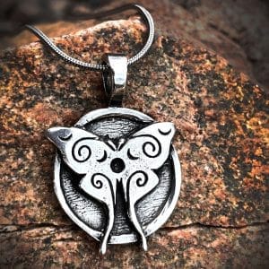 LunaMoth pendant against a wood background