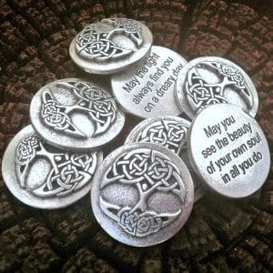A 36 piece pack of Tree of Life Blessing Charms featuring Celtic knot designs and engraved inspirational quotes, displayed on a textured dark surface.
