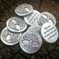 A 36 piece pack of Tree of Life Blessing Charms featuring Celtic knot designs and engraved inspirational quotes, displayed on a textured dark surface.